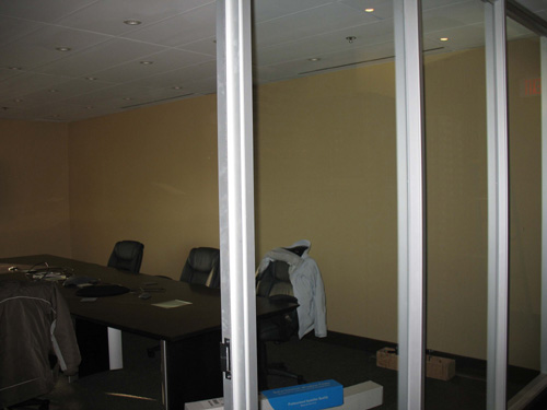 boardroom with glass curtain wall before window film 